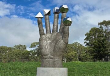The Hand of Plato sculpture on the grounds of The Mathema Gallery.