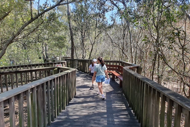 Two girls walking on the boardwalk at Osprey House.