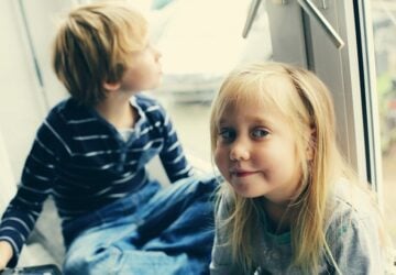 brother and sister sitting by the window